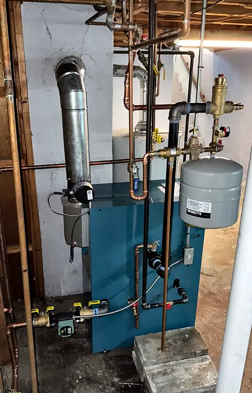Boiler in a basement with an expansion tank, air separator, and circulator pump