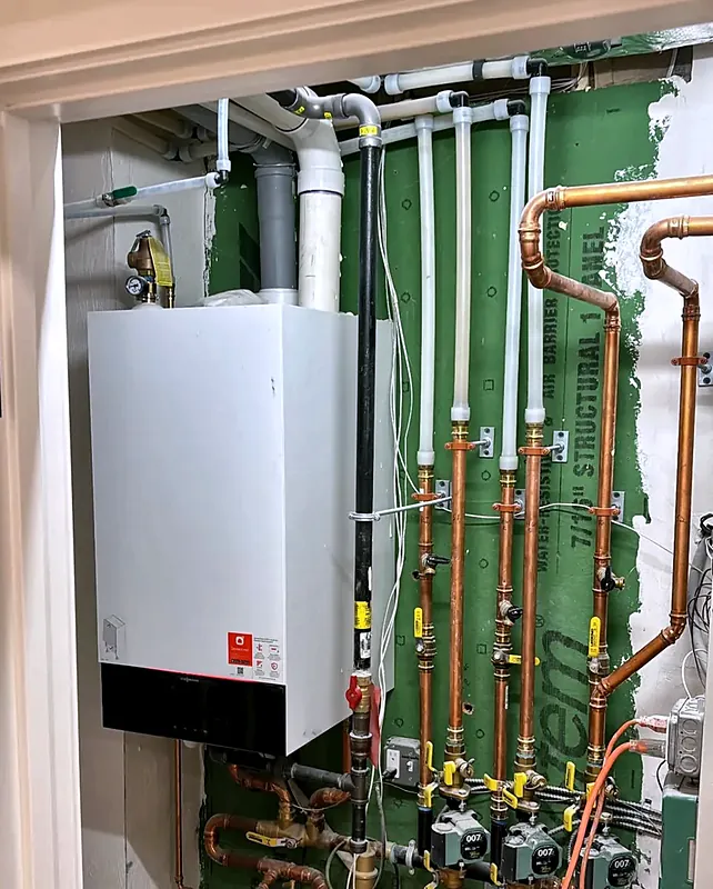 Viessmann wall-hung boiler with copper and PEX piping in a utility closet