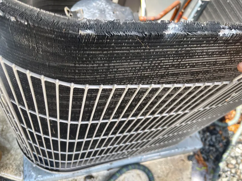 Condenser coil after cleaning, behind the wire guard