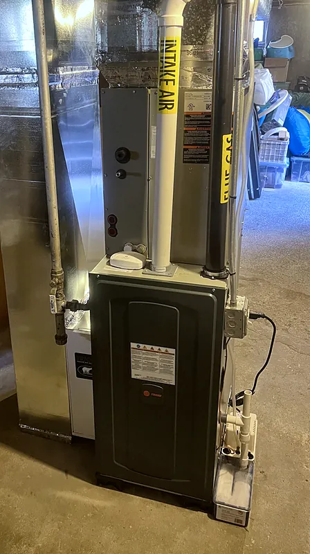 High-efficiency gas furnace with PVC intake and flue in an unfinished basement