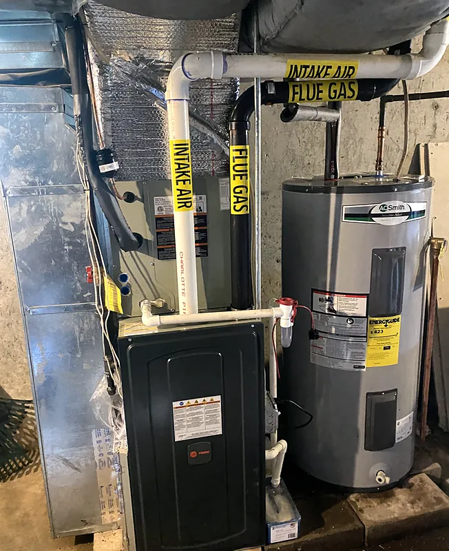 High-efficiency gas furnace beside an A. O. Smith tank water heater
