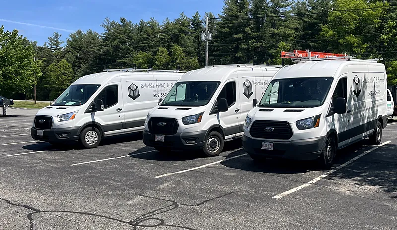 Three Reliable HVAC service vans parked in a row