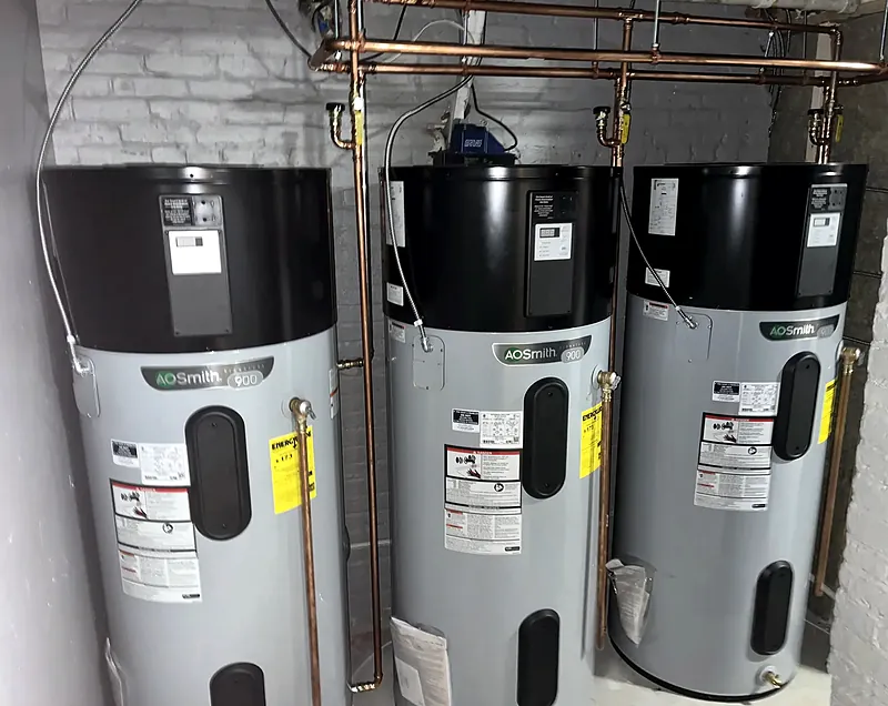 Three A. O. Smith hybrid heat pump water heaters installed side by side